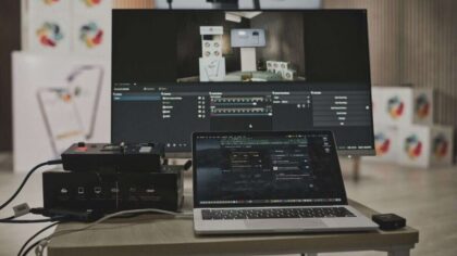 Multimedia setup featuring a laptop and a large monitor in a tech-savvy workspace.