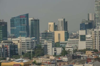 A vibrant urban skyline showcasing modern skyscrapers and diverse architecture on a clear day.