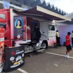 Nasabah sedang menggunakan layanan mobil ATM keliling Bank Jakarta di area Jakarta Kreatif Festival, Istora Senayan.
