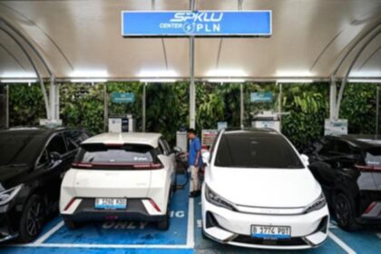 Ilustrasi mobil listrik yang sedang mengisi daya di stasiun pengisian kendaraan listrik umum di Jakarta.