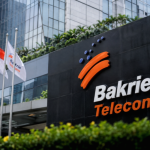 Gedung perkantoran Bakrie Telecom di Jakarta dengan latar belakang logo perusahaan